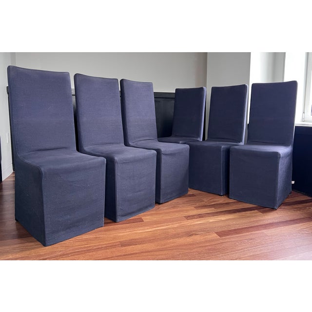 With its fitted slipcover, these Armani Casa high back dining chairs have an elegant and traditional style with a modern...