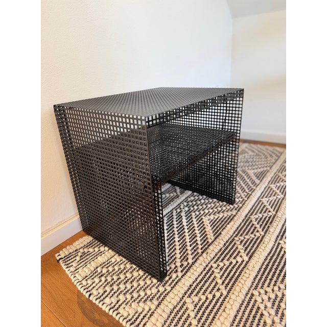 Postmodern side table and hi-fi rack from the 1980s. Construction of black powder-coated perforated sheet metal and metal...