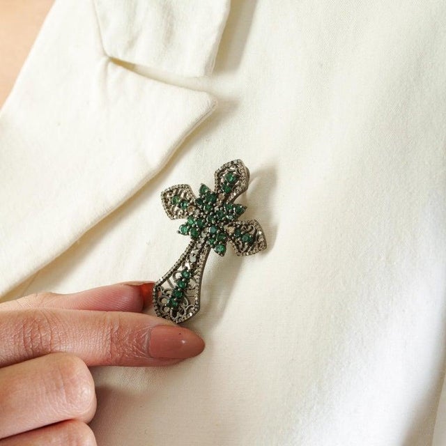 Crafted in luminous 925 sterling silver, this elegant brooch cum pendant showcases the timeless beauty of natural emeralds...