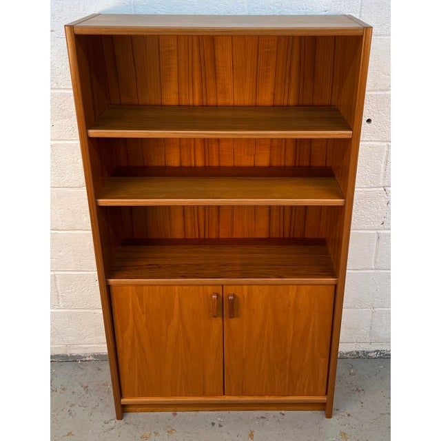 A beautifully crafted mid-century Danish modern bookcase in richly grained teak, offering the perfect balance of...