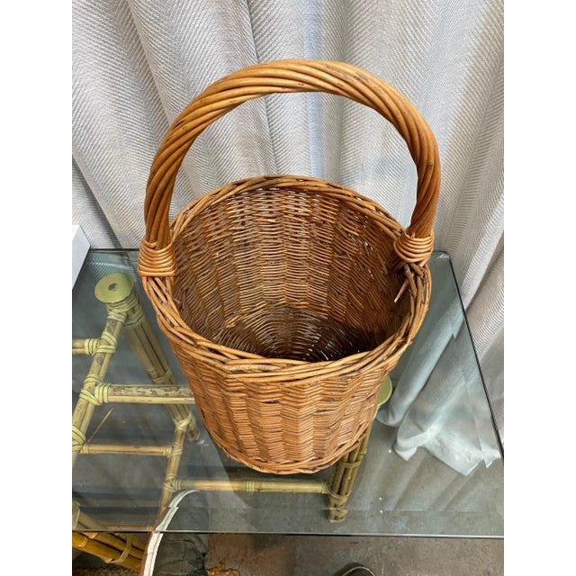 Vintage rattan handmade tube style natural wicker handled basket.