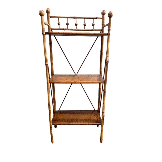 Antique English style bamboo etagere featuring a scorched or burnt bamboo frame with 3 shelves. In the style of Victorian...