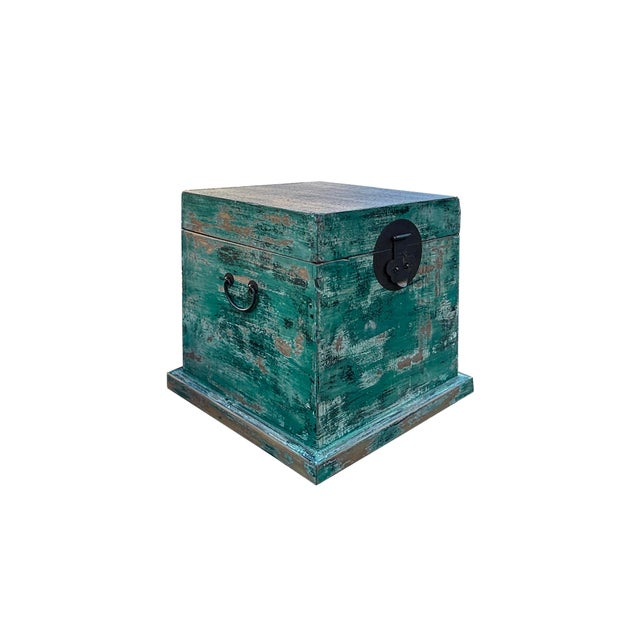 This rustic wooden chest exudes a weathered, vintage charm with its distressed, teal green white finish that reveals...
