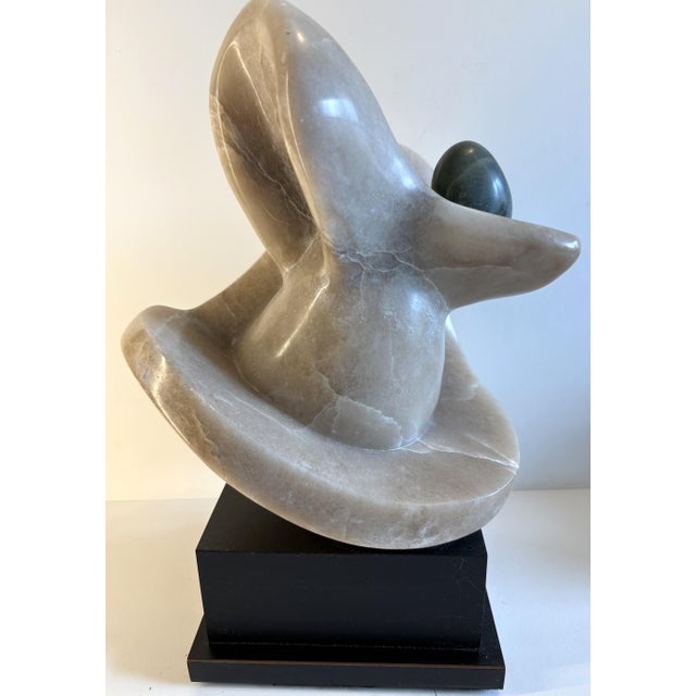 A delightful modern abstract polished marble stone sculpture. The work is well executed and is mounted on a rotating base...