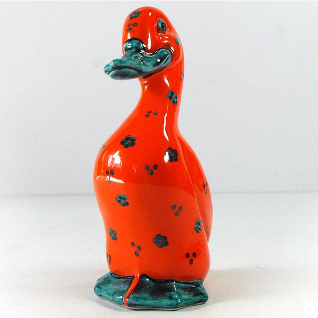 Figurine of a ceramic duck in a piggy bank. Hand-painted and glazed with high gloss. It comes from Italy in the 1960s....