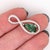This pendant in 14K white gold is stunning with natural diamond infinity design halo and a pear shape green tourmaline...