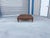 Mid-century leather ottoman designed and manufactured in the United States, circa 1970s. This generously scaled ottoman...