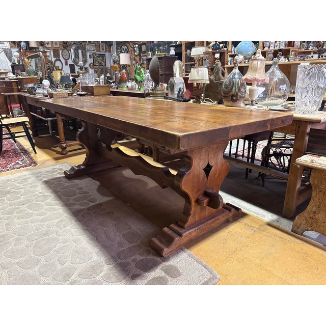 Elegant French monastery-style dining table crafted from solid wood, featuring a striking thick plank top with a...