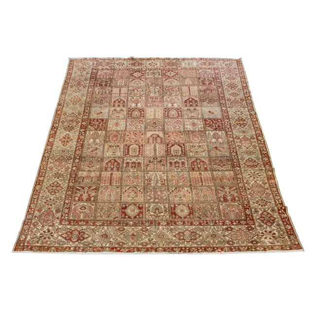 Beautiful Antique Bakhtiari hand-knotted wool rug with a red-rust, blue, beige, and peach color field. This Persian piece...
