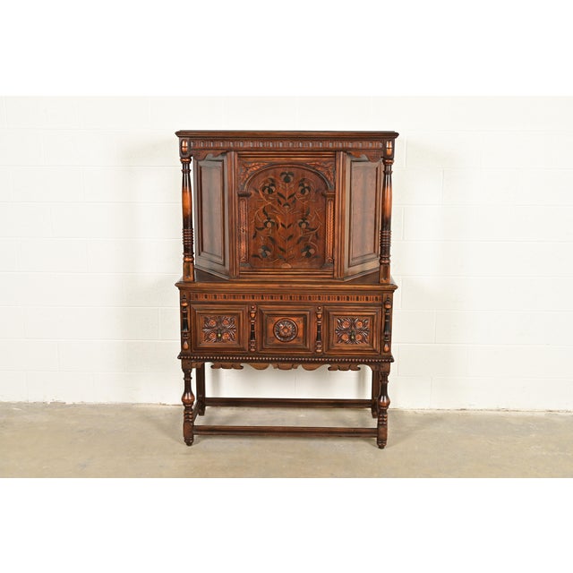 An exceptional English Jacobean or Tudor style bookcase, china hutch, or bar cabinet By Berkey & Gay USA, Circa 1920s...
