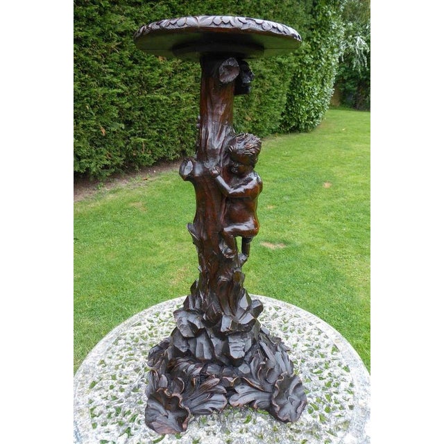 Victorian Carved Country Oak Figural Torchère with Climbing Boy, circa 1850–1860 Material: Country Oak A charming and...