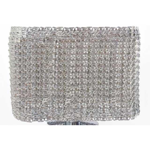 Offering a wonderful Italian table lamp called the Isotta by Visionaire. It is made with chain link metal aluminum as the...