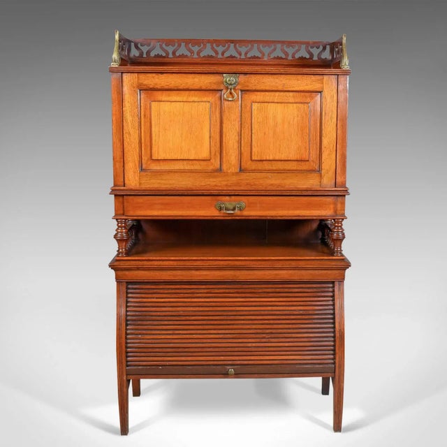 This is an antique bureau cabinet, an English, Edwardian, walnut cupboard dating to, circa 1910. A craftsman's piece in...