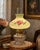 Charming mid-20th-century glass lamp shade featuring a softly luminous pale green finish and delicate hand-painted rose...