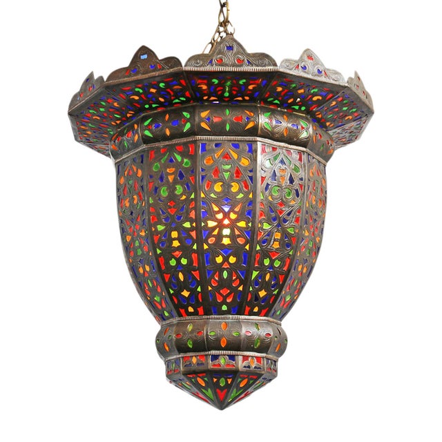 A striking example of traditional Moroccan metalwork, this vintage pendant light is crafted from hand-cut brass and...