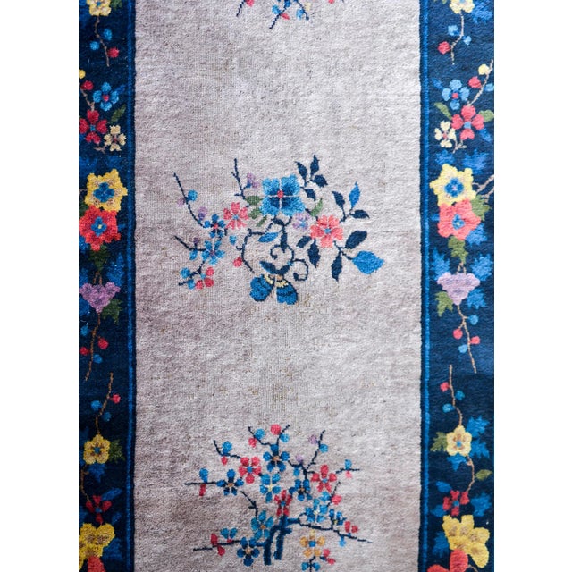 A wonderful Chinese Art Deco runner with a gray field with five multi-colored cherry blossom medallions surrounded by an...