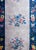 A wonderful Chinese Art Deco runner with a gray field with five multi-colored cherry blossom medallions surrounded by an...