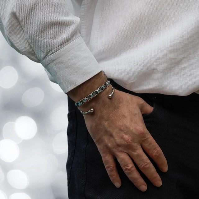Turquoise Evil Eye Sterling Silver Cuff Bangle Bracelet is a captivating blend of artisan craftsmanship and timeless...