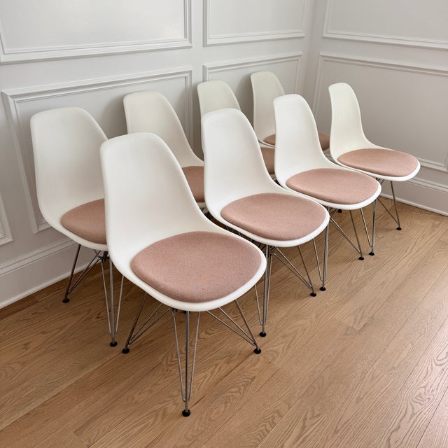 Set of 8 Eames Molded Side Chairs with Pink Pads Designed by Charles and Ray Eames, this iconic modern chair appeared as a...