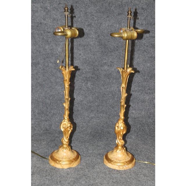 This pair of gilt doré bronze Belle Époque style table lamps, attributed to the legendary Maison Jansen, embodies the...