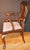 This pair of antique arm chairs in the George II style, in mahogany and mahogany veneer, have superior hand-carved and...