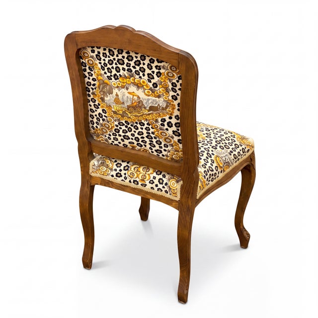 This is a 1950s carved oak French side chair that was upholstered in a 1970s Brunschwig & Fils leopard chinoiserie. It is...