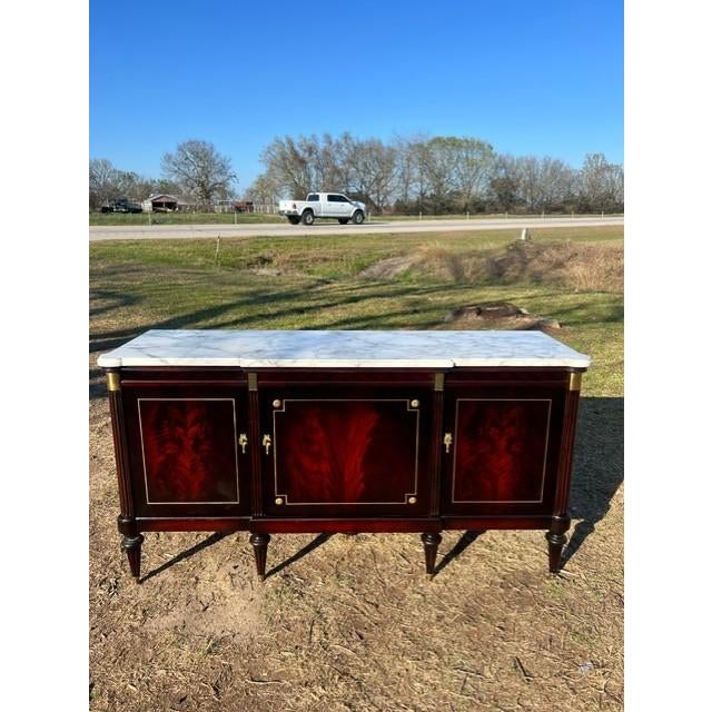 Spectacular French antique Louis XVI sideboard made of flam mahogany, The wood has been finished with a lustrous French...