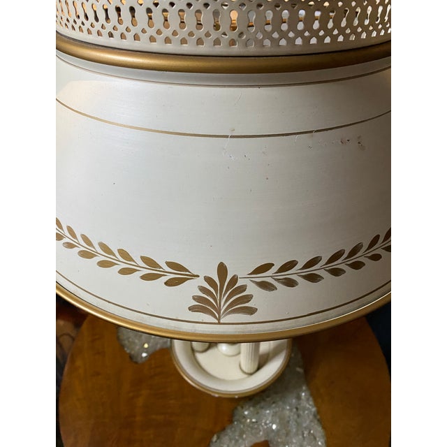 This MCM Tole Bouillotte candlestick lamp is a traditional French table lamp, characterized by its metal base and...