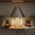 Punched tin metal lampshade featuring pierced birds, hearts, and scrolling vine designs. The tapered shade has an aged...