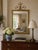 An elegant early-20th-century mirror in the Adam style, with a slender giltwood and composition frame crowned by an airy...