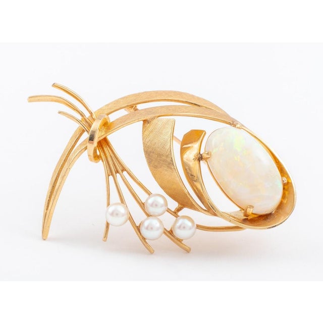 A pin made in 14K yellow gold, with a Florentine finish on front sides and brightly polished on the rear surfaces,...