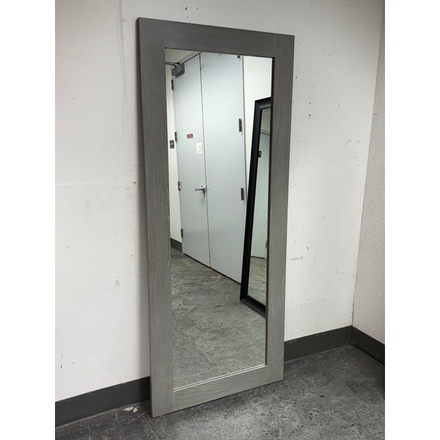 Design Plus Gallery presents a Gray Hanging/Leaning Floor Mirror from CB2. The woodsy grey border frames a full-length...