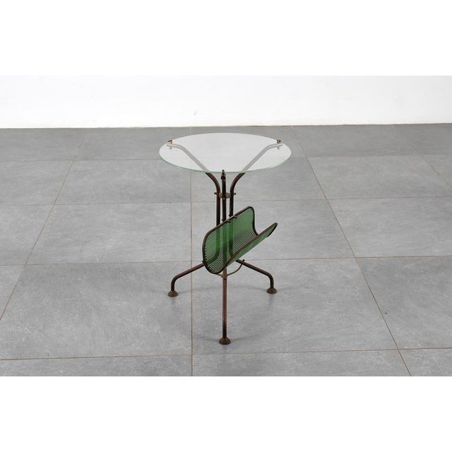 Beautiful Italian brass circular table with glass top from the 1950s. Original brass base with three curved legs and...