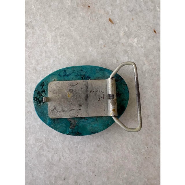 It’s very rare, unique, large piece of solid turquoise made into a sleek belt buckle.