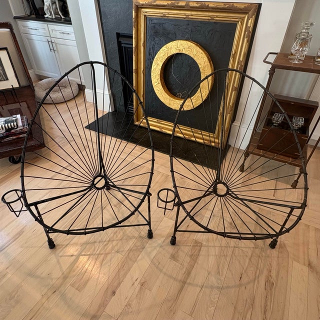 A striking and wonderfully unusual pair of vintage Acapulco-style lounge chairs, handcrafted in heavy welded steel with...