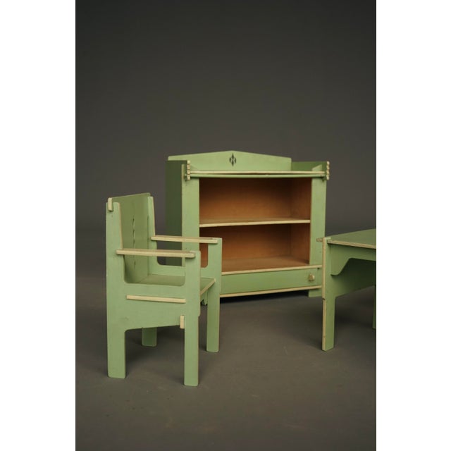 A rare and charming set of four pieces of miniature furniture or toy furniture. Painted plywood constructions in the style...