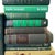 A collected library in shades of forest, emerald, olive, and sea green. These 24 hardcover books bring varied heights,...