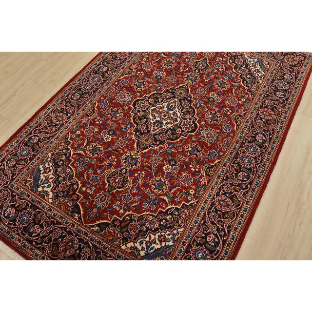 An authentic vintage traditional Kashan rug hand-knotted with fine wool and natural dyes. This oriental rug features a...