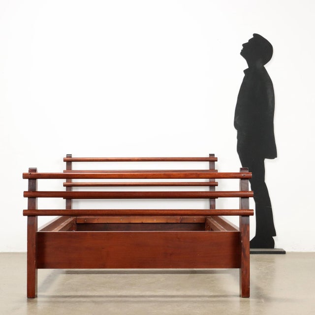 Vintage wooden double bed frame. This piece is attributed to the mentioned designer/maker. It has no attribution mark and...