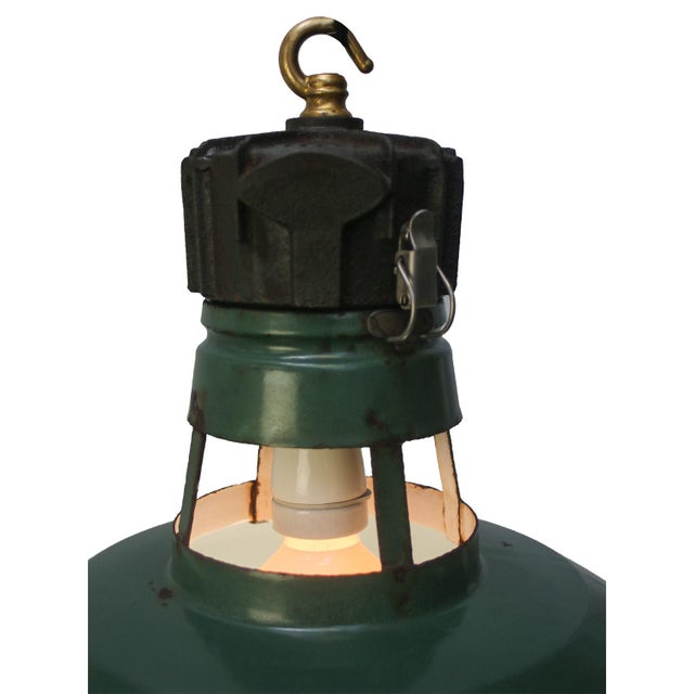 French industrial pendant lamp made by sammode, france. petrol green enamel with white inside, cast iron top with brass...