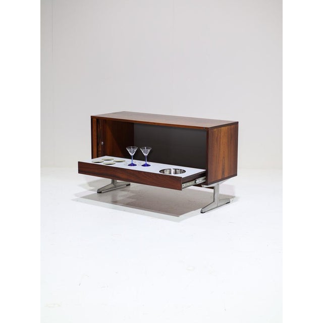 A unique bar cabinet manufactured by nipu møbler, denmark, in the 1960s. Set on aluminum legs, this low cabinet is crafted...