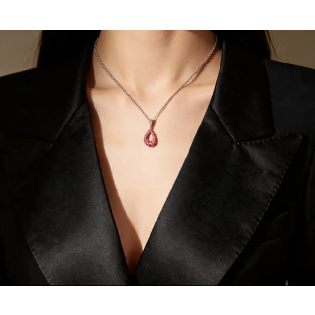 Material: .925 Sterling Silver Stones: Round Diamonds - total 0.4 carats (~1 mm each) Design/Feature: Pink Enamel Pendant...