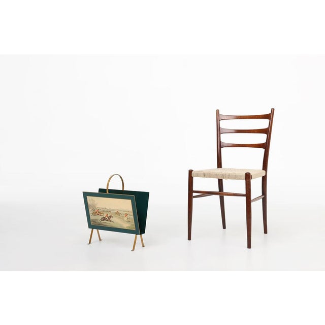 A characterful 1950s French magazine holder in painted metal, blending mid‑century practicality with the decorative flair...
