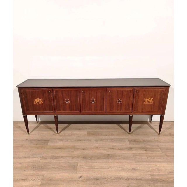 Wooden sideboard with five inlaid doors and a stained glass top. Designed by Paolo Buffa. It features an embossed stamp...