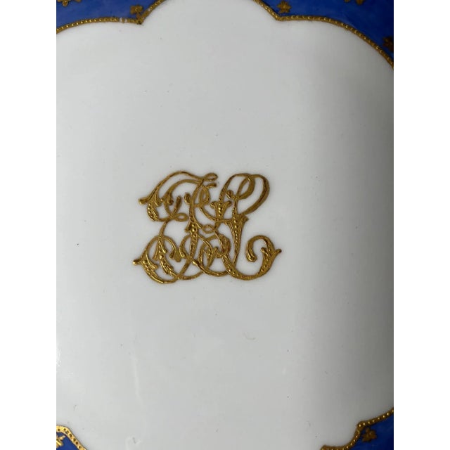 The ornate decoration on this Elite L France plate, with the cobalt blue rim with gold floral patterns and scalloped...