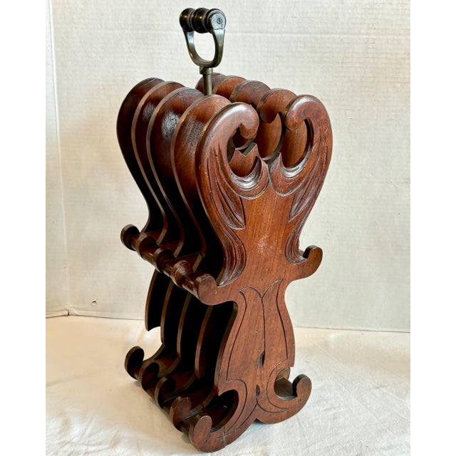 Nicely fashioned in mahogany. A nice chair side or table side design with a handle. Unusual form , nice quality.