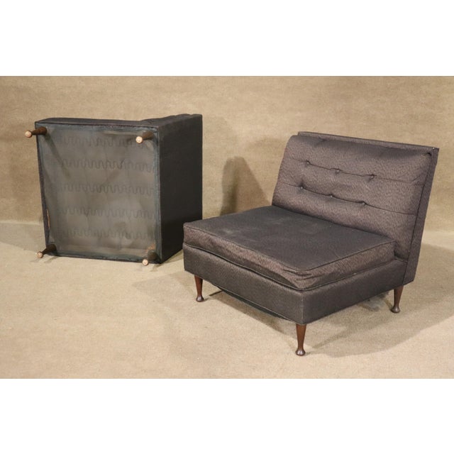 Pair of mid-century modern low profile slipper chairs. Tufted backs and short wood legs.
