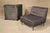 Pair of mid-century modern low profile slipper chairs. Tufted backs and short wood legs.