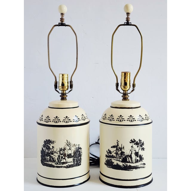 Vintage Italian made French inspired tole painted tea caddy table lamps. The lamps feature French toile style motifs on...