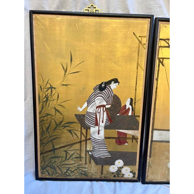 A pair of antique Japanese hand painted landscape scenes on a woven media. The scene depicts women weaving textiles among...